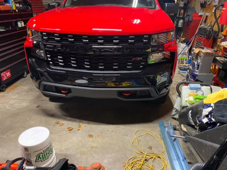 Red Chevy Silverado front end in the shop