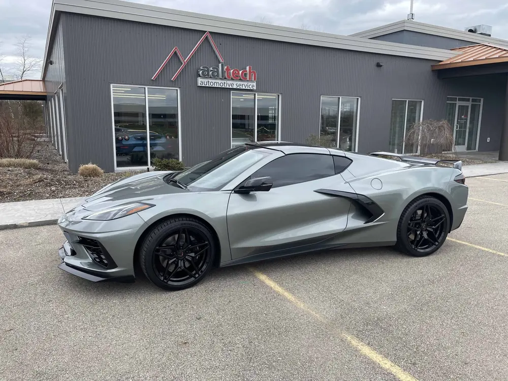 Silver C8 Corvette parked outside