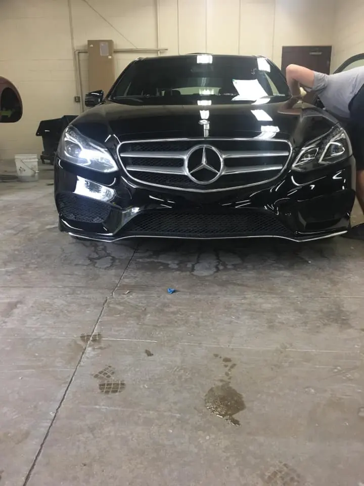 Black Mercedes-Benz sedan in the shop