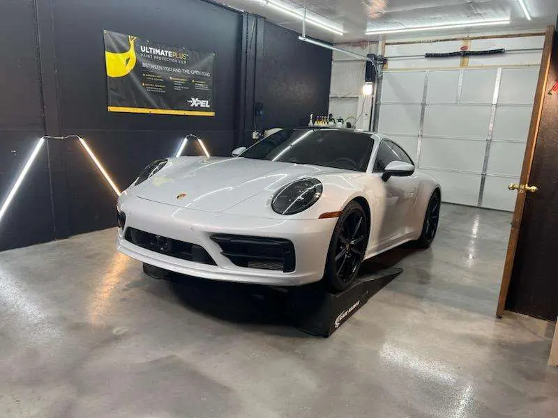 White Porsche 911 parked in the XPEL install bay